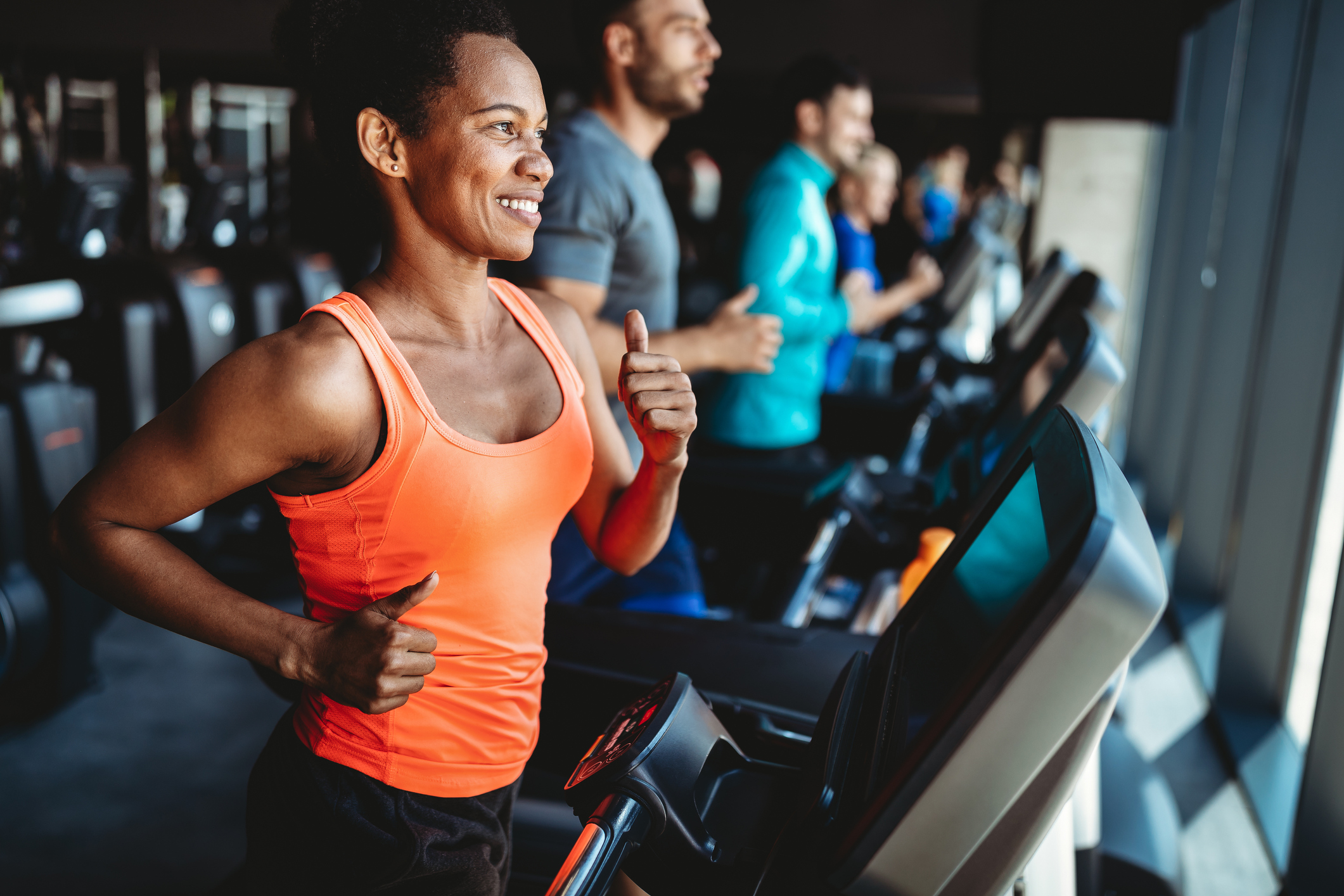 Happy woman smiling and working out in gym