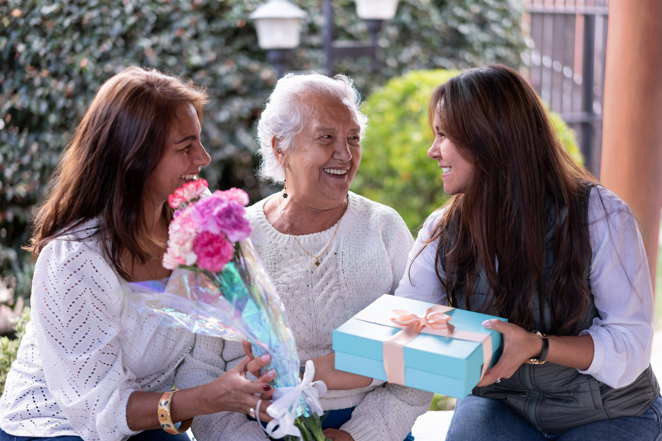 Three generations portrait celebrating motherâs day all smiling very happy