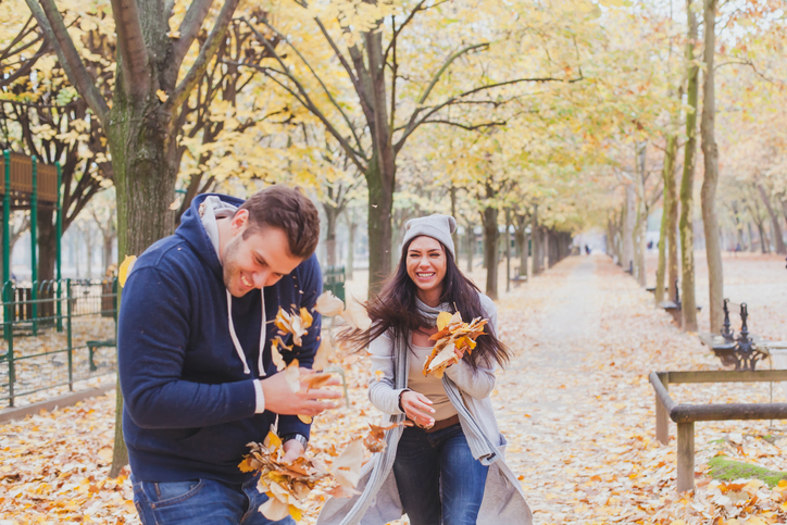 happy young couple playing in autumn park